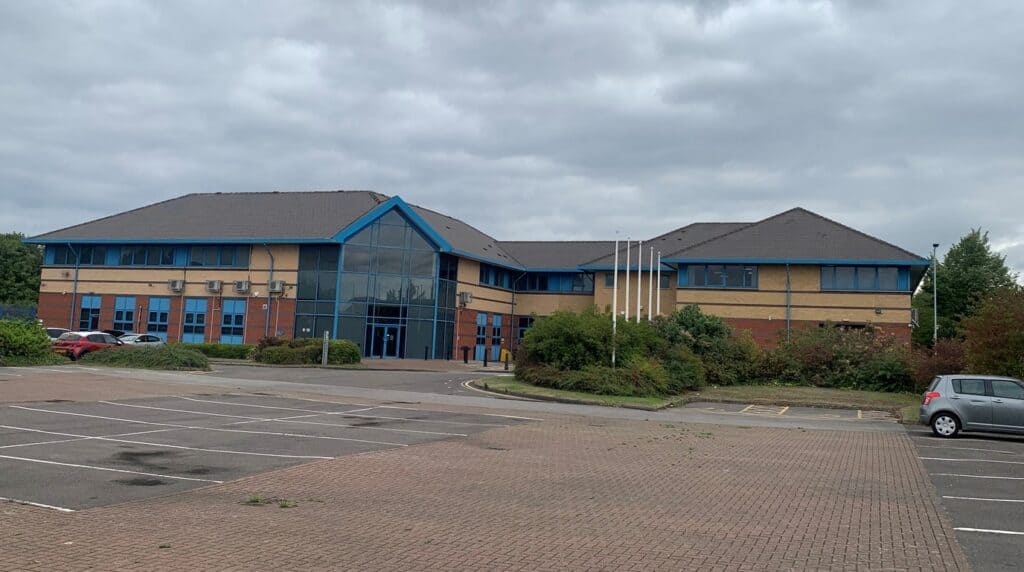 Reresby House, Rotherham — a vacant modern office building with an empty car park