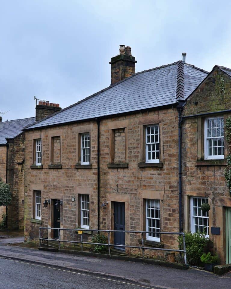 Stone houses with climbing plants on South Church Street in Bakewell, Derbyshire