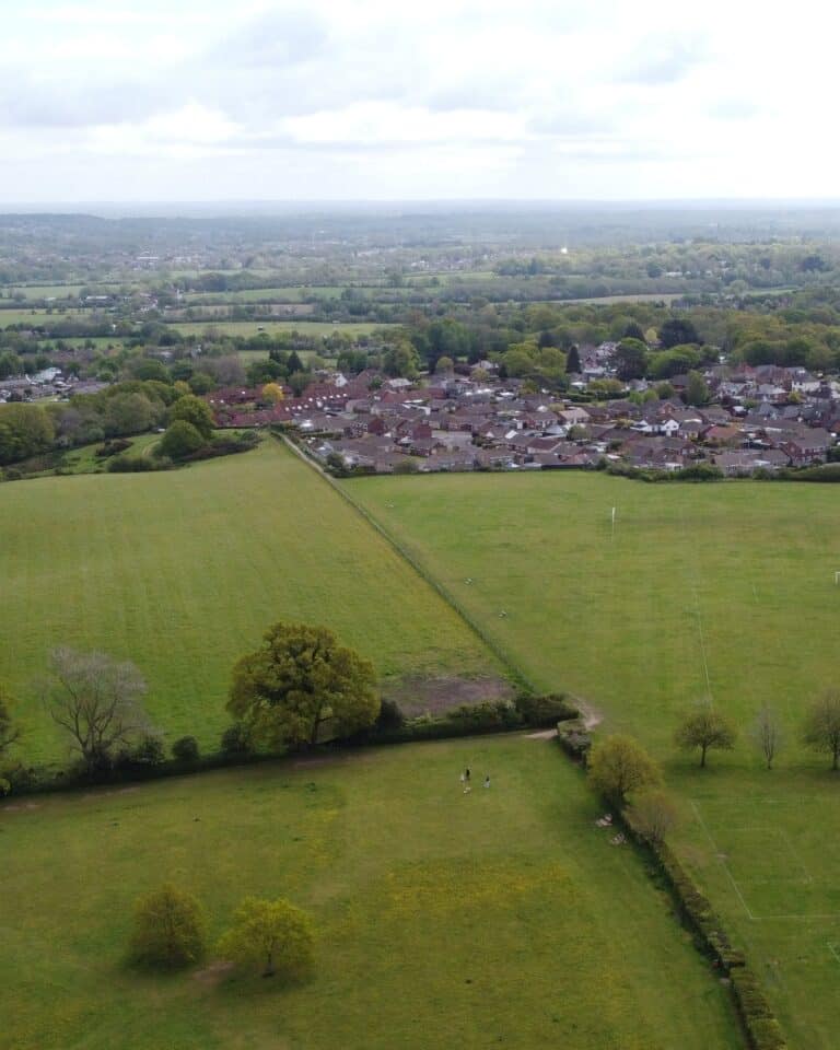 Housing on the edge of a town meeting open farmland, the boundary typical of Green Belt land