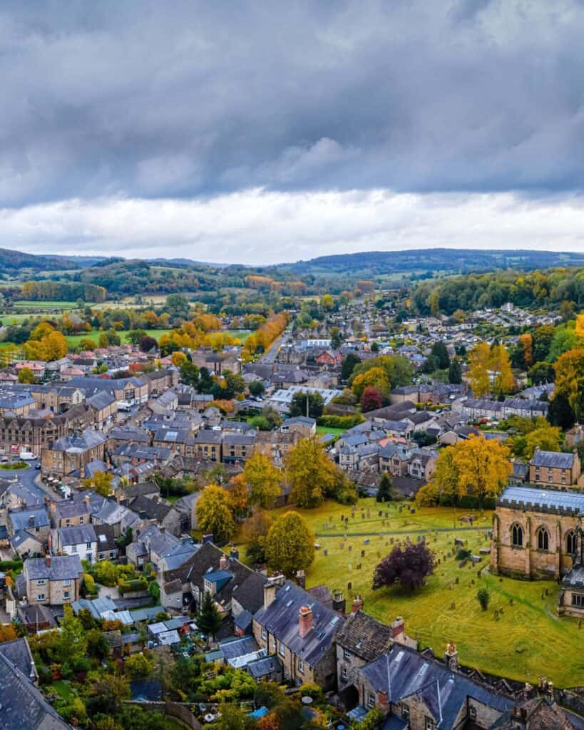Aerial view of Bakewell with the spire of All Saints Church above the stone rooftops