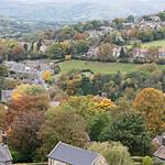 Stone houses and autumn trees at Hathersage, with the Peak District moors beyond