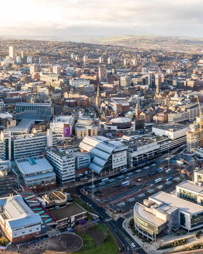 Aerial view over Sheffield city centre at sunset, with hills on the horizon