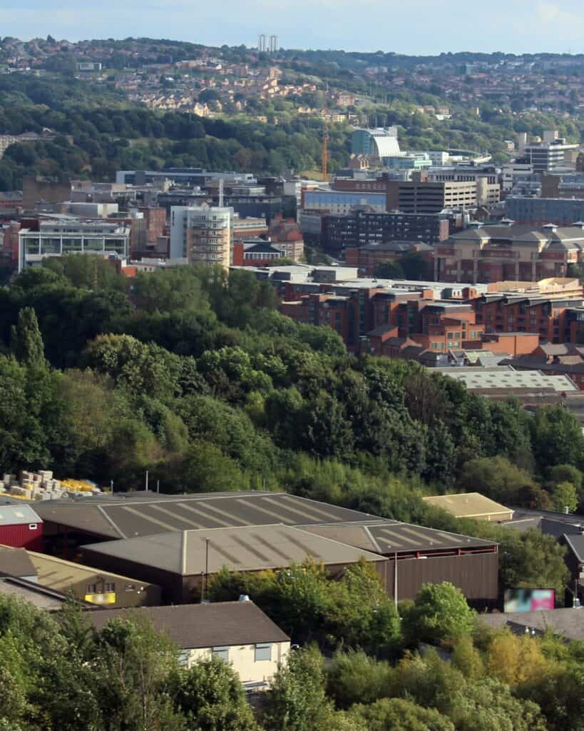Sheffield seen from Parkwood Springs, industrial buildings below a wooded hillside