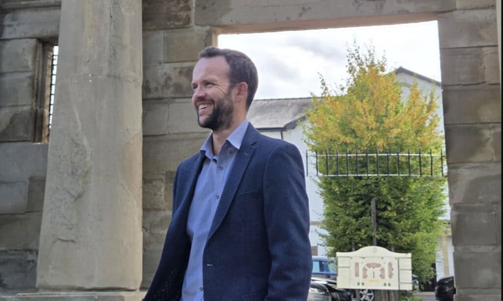 Richard Pigott, Managing Director, beneath the stone arch at Vernon Gate in Derby