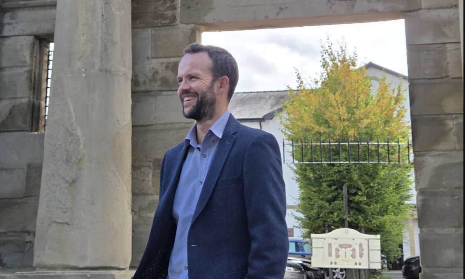 Richard Pigott, Managing Director, beneath the stone arch at Vernon Gate in Derby
